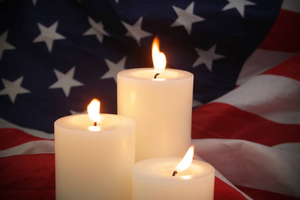 istock Burning candles on USA flag background. 1480016307