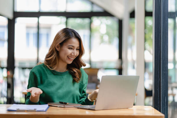 istock young woman working in a cafe using laptop and drinking coffee Asian female student using a computer for distance learning sitting on a bench in the shop casual lifestyle people and technology lifestyle 1480017694