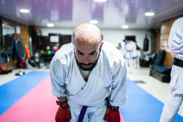 istock Mid adult man bowing during a karate class 1480018985