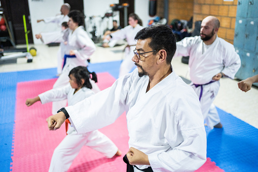 Karate students punching the air during a karate class