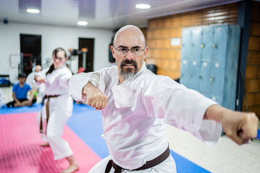 Mature man practicing during a karate class