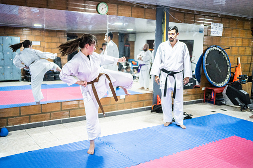 Karate sensei teaching a student girl at karate class