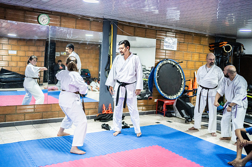 Karate sensei teaching a student girl at karate class