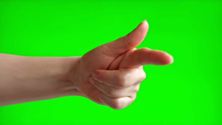 Person pointing at something forward with index finger Isolated On Green Screen Background. Close Up. Human Hand pointing ahead, to side with one finger to front on Chroma Key Screen. Forth gesture