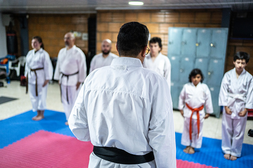 Karate sensei talking with students at karate class