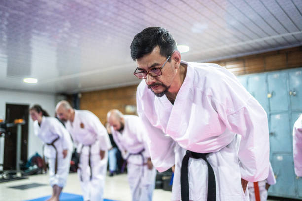 istock Karate sensei bowing with students at karate class 1480024560