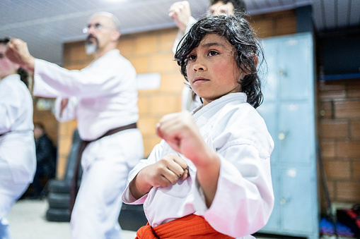 Child boy practicing during a karate class