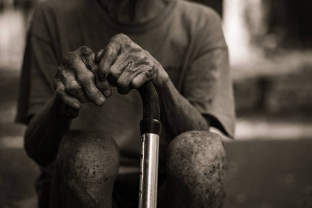 Old man's hand wearing a cane at home