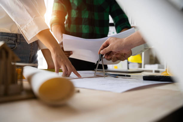 istock architect or engineer team working on table use drawing tool on the paper plan for business architectural project. 1480028350
