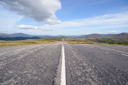 Open road on beautiful sunny day, Scottish Highlands near Loch Ness and Inverness.