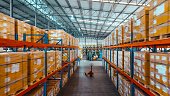 Point of view of merchandise packages stores on shelf rack in factory warehouse. Logistic industry business, industrial job career, factory work environment concept