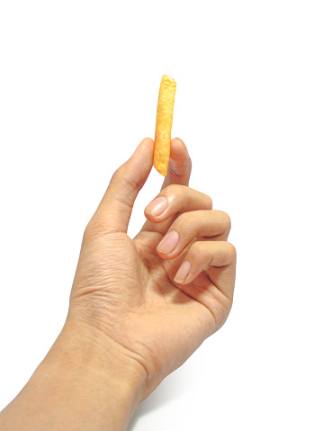 Left hand holding the French fries potatoes isolated on white background with clipping path.
