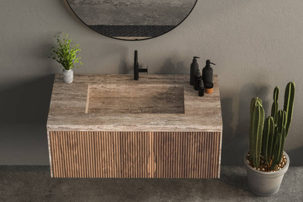 istock 3D render close up blank empty space on vanity unit counter top with wash basin, modern black faucet in an exotic style bathroom. Tropical decor plants. 1480031835