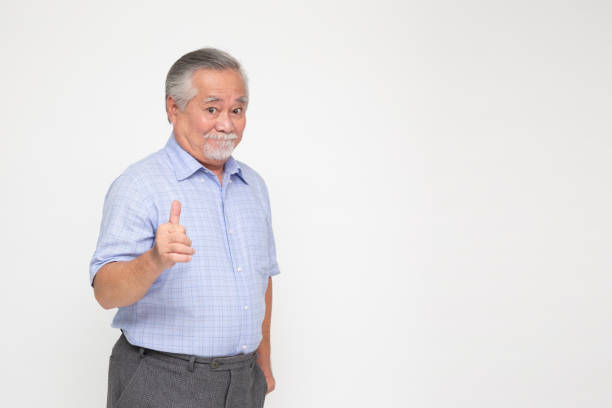 Asian senior man showing thumbs up isolated on white background