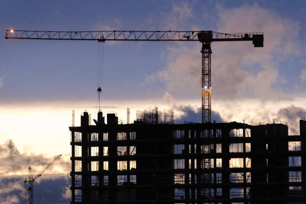 istock Tower crane, workers work at construction site. Process of building new houses 1480033689