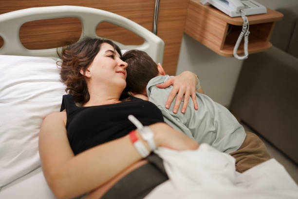 istock Expectant mother hugging his first kid in bed. 1480039516