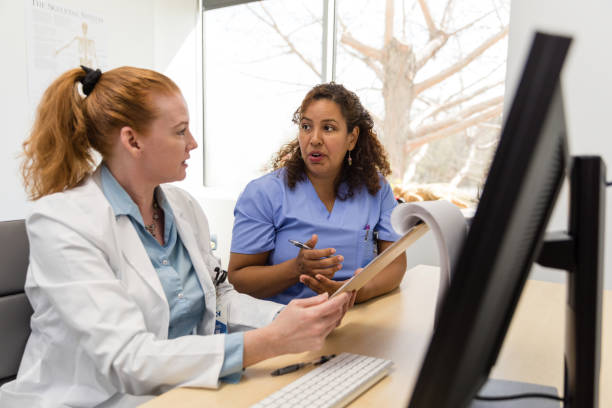 istock Healthcare professionals sit at the computer desk to work on a training module 1480040622