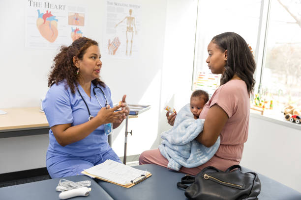 istock Female pediatrician gestures while talking to the young adult mother 1480040708