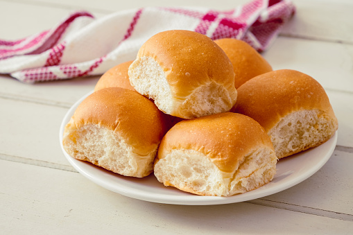 Soft bread rolls on white plate