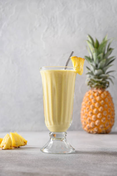 istock Pineapple lassi in glass on gray background. 1480043037