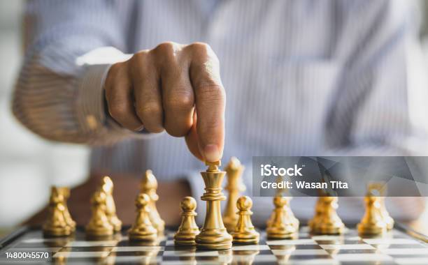 Premium Photo  Person playing chess board game, conceptual image of  businesswoman holding chess pieces against opponent chess against business  competition, planning business strategies to defeat business competitors