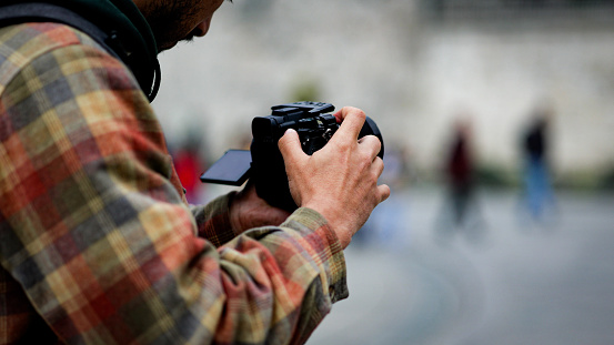 Filmmaker captures cityscape, Man shoots video with camera in hand, Cinematographer shoots outdoor video, tourist shooting istanbul city