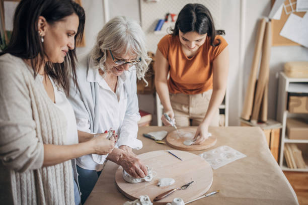 istock Female siblings modeling clay together 1480051832