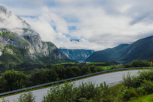 The mountain pass through the fresh green fjord of Western Norway in Eidfjord, Scandinavia