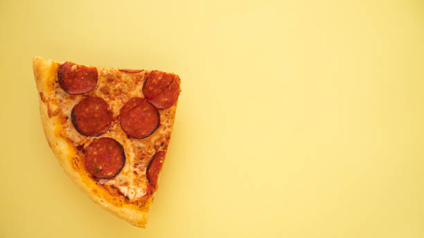 istock Pepperoni pizza on yellow background. Top view. Copy space. 1480052868