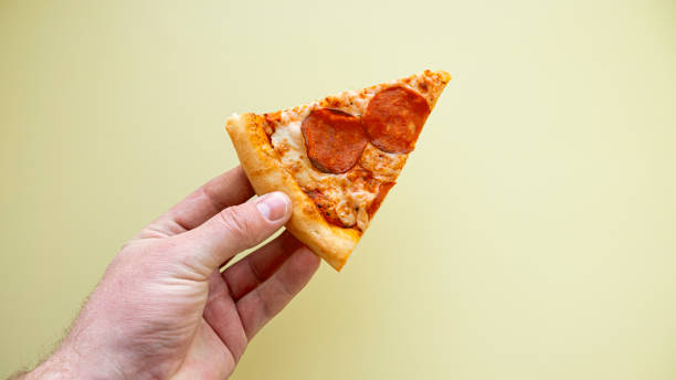 istock Pepperoni pizza on yellow background. Top view. Copy space. 1480052878