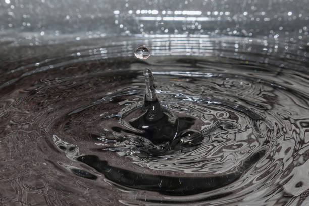 istock Drop of water hitting the water in a tray, forming a wave 1480053151