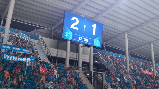 Football Soccer Stadium Championship Match, Scoreboard Screen Showing Score of 2:1. Crowd of Fans Cheering, Screaming, Having Fun. Sports Channel Television Advertising Concept