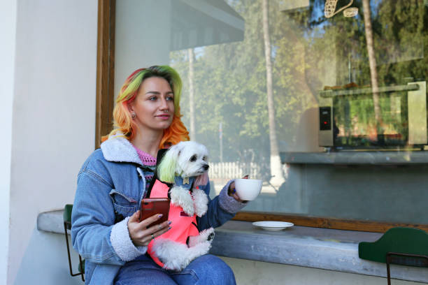 istock Young woman having morning coffee with her dog. 1480057188
