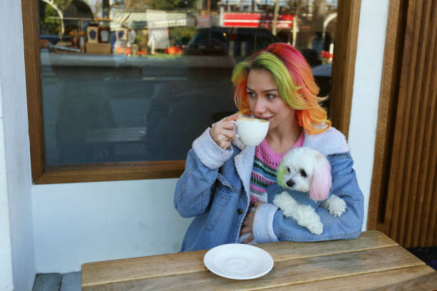 istock Young woman having morning coffee with her dog. 1480057277