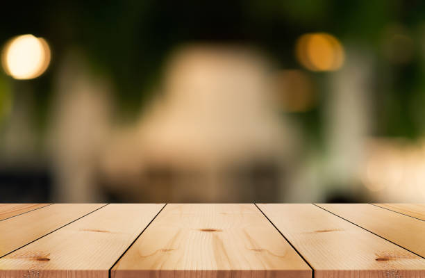 istock Empty wooden table top with lights bokeh on blur restaurant background. 1480061477