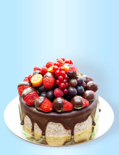 istock Cake decorated with strawberry dipped into melted chocolate, raspberry, blueberry and red currant. Isolated on plain background 1480061944