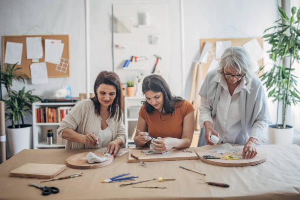 istock Women molding clay together 1480062144