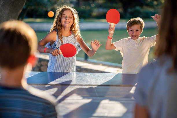istock Children playing table tennis on summer day 1480063649