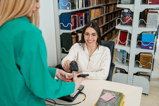 istock Female Student Renting A Book In A School Library 1480066034