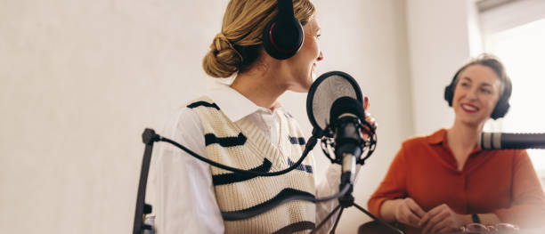 istock Happy radio host interviewing a guest on her show 1480068295