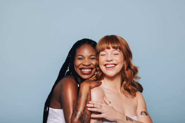 istock Two women with different skin tones standing together in a studio 1480069116