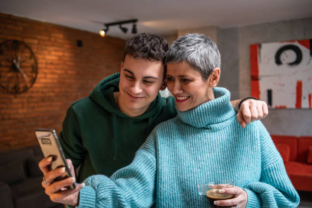 istock Mother and teenage son hugging 1480069217