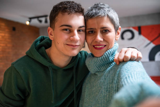 istock Mother and teenage son hugging 1480069366