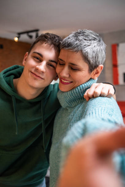 istock Mother and teenage son hugging 1480069378