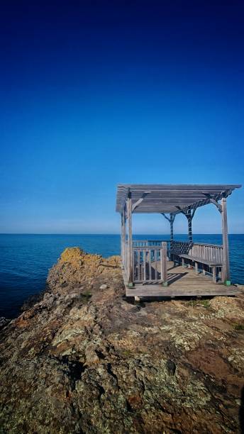 istock Wooden sitting deck on rock overlooking the sea 1480070824