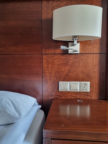 Lamp on side table in bedroom