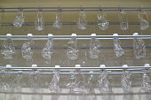Close-Up Of Clear Crumpled Plastic Bottles Hanging In Row