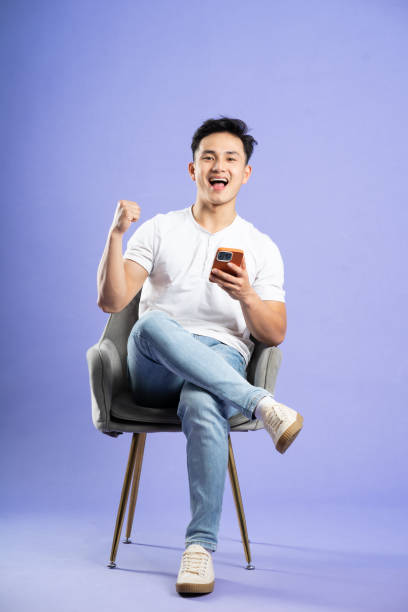 istock image of asian boy posing on purple background 1480074863