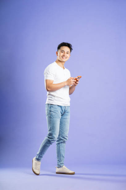 istock image of asian boy posing on purple background 1480075418