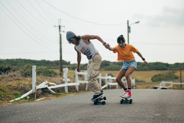 istock Two Asian skateboarding enthusiasts are playing together outdoors, sharing their skateboarding skills with each other and encouraging each other to complete the tricks. 1480078179